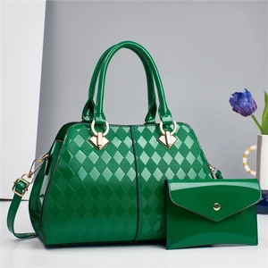 Detail of emerald green patent leather tote with quilted pattern and gold hardware