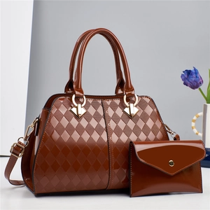 Detail of amber brown patent leather handbag with diamond lattice pattern and matching wallet