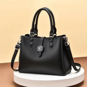 Minimalist black square PU handbag with silver floral buckle and adjustable strap
