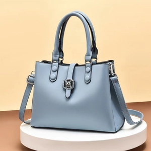Light blue square embossed PU leather handbag with floral metal clasp and shoulder strap