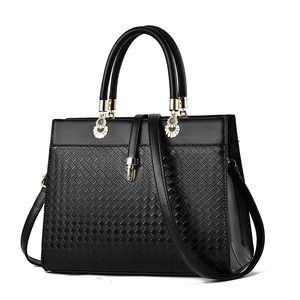 Women's black large tote bag with woven texture, round handles and gold pendant detail