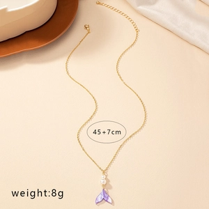 Elegant gold mermaid tail necklace with white pearls and purple glitter pendant