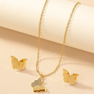 Elegant gold butterfly jewelry set including layered pendant necklace and stud earrings