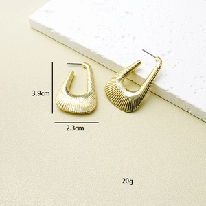Detailed view of gold geometric earrings with textured relief and 3.9cm x 2.3cm dimensions
