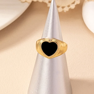 Fashionable gold-plated heart ring with black enamel inlay on a conical ring display