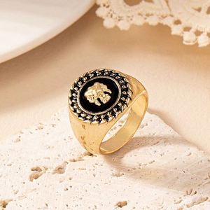Vintage gold signet ring with black enamel and 3D lion head relief on stone base