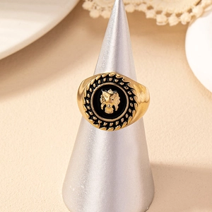Retro lion head signet ring in black and gold finish with braided metal texture
