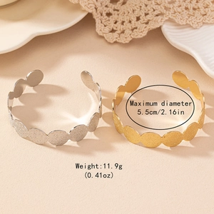 Minimalist matte cuff bracelet with textured wave design in gold and silver finish