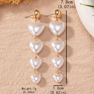 Elegant gold earrings featuring four graduated heart pearls measuring 7.8cm in length