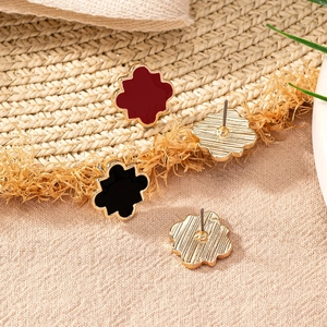 Floral geometric studs with red and black enamel finish on gold metal backing