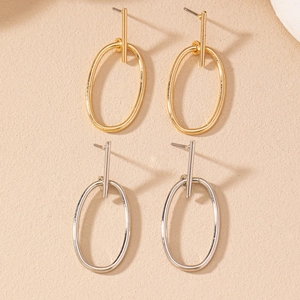 Detail showing minimalist geometric hollow oval earrings in gold and silver finishes