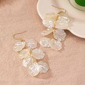 Elegant long tassel earrings with shell flower petals and golden chains on linen