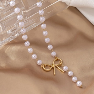 Elegant bow knot pearl necklace with gold-plated metal charm for women's jewelry collection