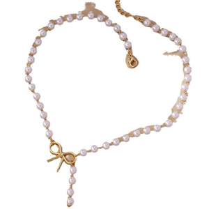 Elegant pearl necklace with golden bow pendant and adjustable chain on white background