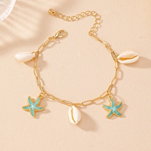 Detailed macro view of starfish shell bracelet with golden chain and blue enamel charms