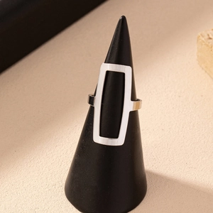 Minimalist silver geometric hollow square ring displayed on a black conical stand