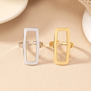 Close-up of geometric hollow square rings in gold and silver with adjustable bands
