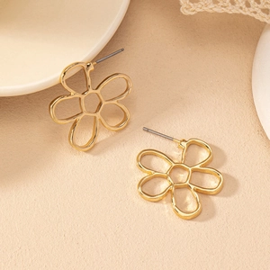 Minimalist gold cutout flower stud earrings with sleek polished metal lines and five petals