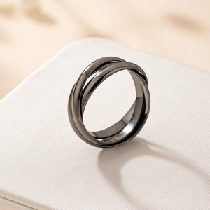 Minimalist black triple-intertwined metal ring set on a textured white display box