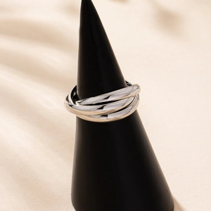 Polished silver trinity interlocking triple band ring on a jewelry display stand
