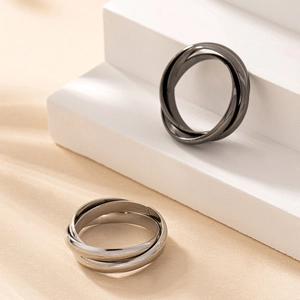 Detail of interlocking triple bands ring in gunmetal grey and silver finish
