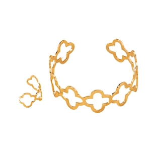 Golden hollow floral jewelry set featuring an open bangle and matching adjustable ring