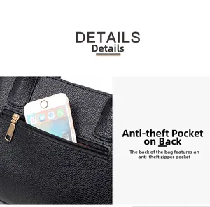 Détail de la poche antivol arrière sur un sac bandoulière noir à motif litchi avec téléphone