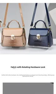 Close-up of lizard pattern handbags featuring golden rotating metal locks and fine stitching
