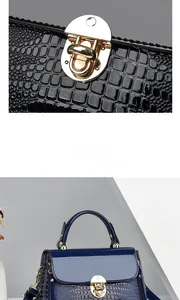 Detailed close-up of lizard-pattern leather texture and golden metal buckle on blue bag