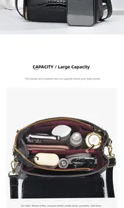 Lizard texture shoulder bag detail showing interior capacity and golden hardware