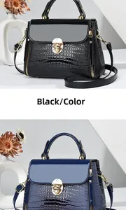 Detail of glossy lizard pattern leather handbag with gold twist lock and shoulder strap