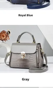 Detail of lizard embossed leather texture and gold twist lock on blue and grey crossbody bags