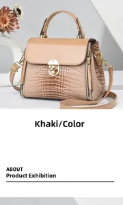 Detail of khaki lizard-embossed leather handbag with gold metal clasp and zipper