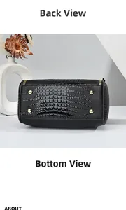 Detail of black lizard pattern crossbody bag with golden protective metal feet