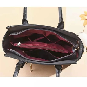 Large capacity black snakeskin tote bag with multi-compartment red interior and gold hardware