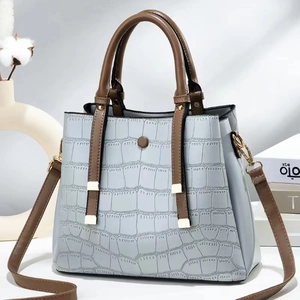 Detailed stone-patterned trapezoid handbag with gold hardware and brown handles
