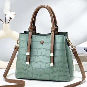 Mint green crocodile embossed tote bag with brown handles and golden hardware detail