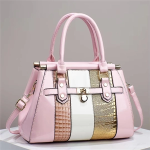 Pink patent leather tote bag with tricolor lizard pattern and gold metal lock detail