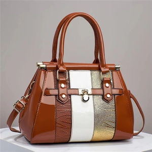 Detail of lizard-textured handbag with gold-tone hardware and vertical color blocking