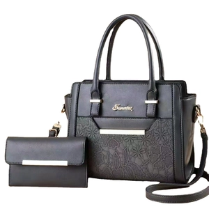 Black faux leather two-piece tote bag and wallet set with floral lace pattern and gold hardware