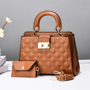 Detail shot of caramel brown quilted handbag set with gold hardware and shoulder strap