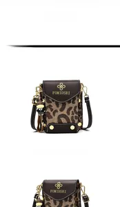 Detail view of mini leopard print phone bag with gold logo and black cow charm