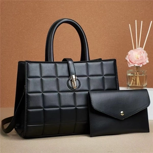 Chic black embossed two-piece handbag set with tote and envelope clutch for women