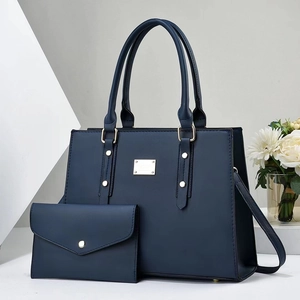 Elegant navy blue tote bag and matching wallet set with golden metal hardware and strap