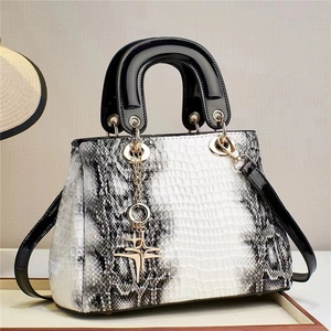 Fashionable crocodile texture shoulder bag with star pendant and sleek contrast design