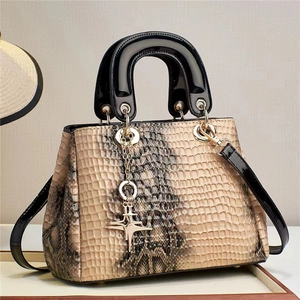 Elegant crocodile pattern tote bag in beige with black handles and gold star pendant