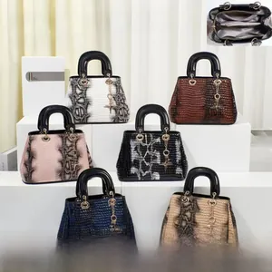 Detail view of multi-color crocodile and snake pattern handbags with interior compartments