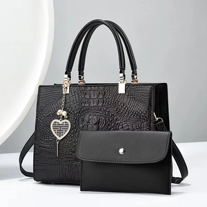 Black crocodile pattern tote bag set with heart pendant and matching envelope clutch bag