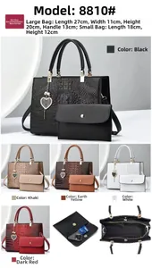Detail view of large crocodile embossed leather tote bag with matching inner pouch