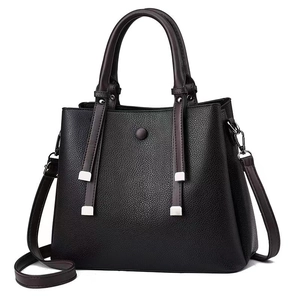 Black pebbled leather tote bag with contrast fringe details and adjustable shoulder strap